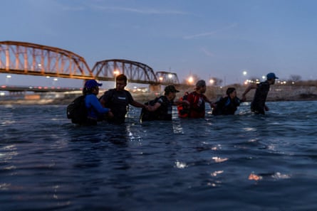 people walk in a river