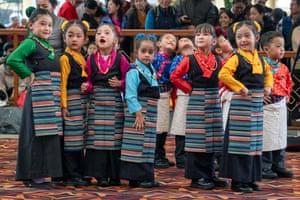 A row of young children in traditional Tibetan clothes