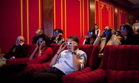 US president Barack Obama and first lady Michelle Obama wear 3-D glasses while watching the 2009 Super Bowl.