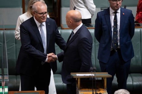The leader of the Opposition Peter Dutton gets a handshake from former PM Scott Morrison as he prepares to deliver the budget in reply in the house of representatives chamber of parliament house in Canberra this evening. Thursday 27th October 2022.