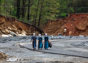 Amish volunteers walk down a temporary road in Chimney Rock