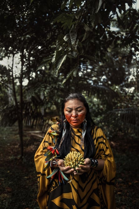 Eliane pictured in traditional dress with trees in the background