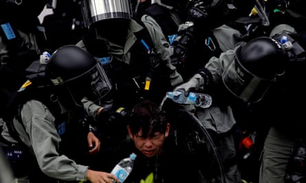 Riot police detain an anti-government protester in Sheung Shui, a border town in Hong Kong