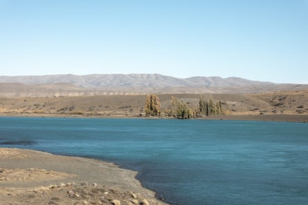 A wide river between barren landscape