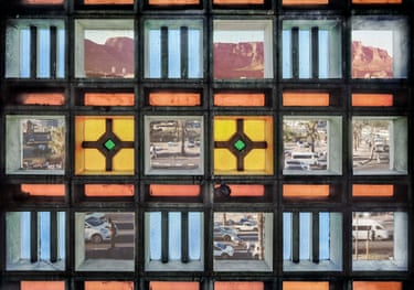 Composite view through old Cape Town station windows, showing mountains, streets and coloured glass panes