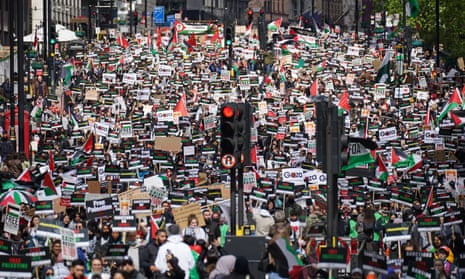 Protesters walk along Piccadilly in central London, during a march in solidarity with the people of Palestine.