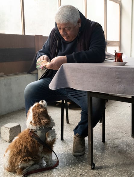 Pera, Şebnem Köker’s pet dog, being fed by father Abdullah in a cafe near the family home in Izmir, Turkey