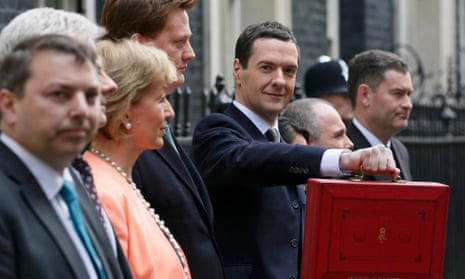 George Osborne, holds up his budget case for the cameras as he stands with his Treasury team outside number 11 Downing Street.