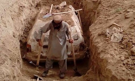 A white Toyota once belonging to Taliban leader Mullah Omar being dug up.