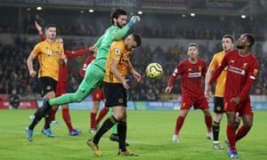 Liverpool’s Alisson is fouled by Wolverhampton Wanderers’ Romain Saiss.