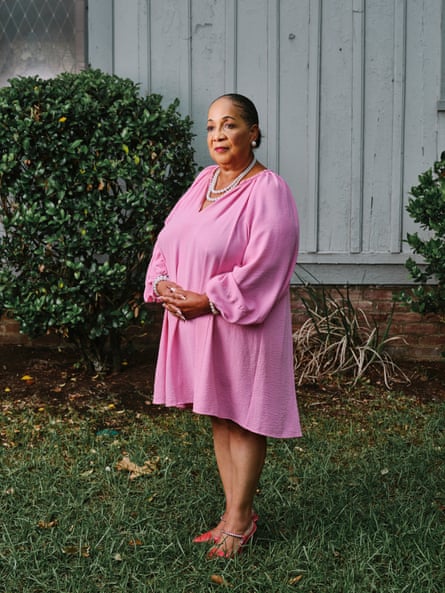 A woman in a pink dress posing