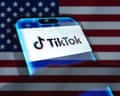 A smartphone displaying the logo of TikTok backdropped by cropped flag of the United States.