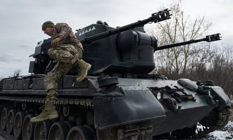A Ukrainian soldier on a German-manufactured anti-aircraft gun in the Kyiv region on 23 November.