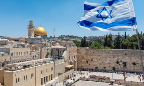 The Israeli flag flutters above the Western Wall in Jerusalem.