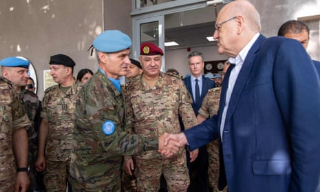 man shaking hands with another man in military clothing
