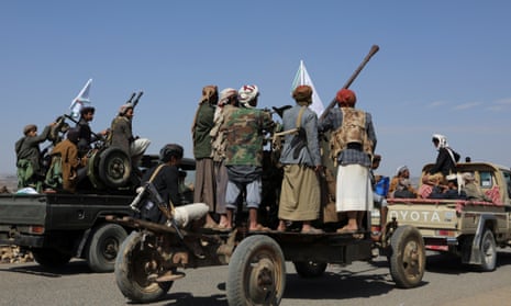 Houthi tribesmen ride vehicles with mounted guns
