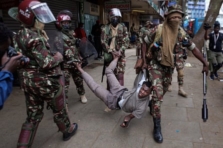 Anti-riot police officer arrest a suspected protester during an anti-government demonstration in Nairobi.