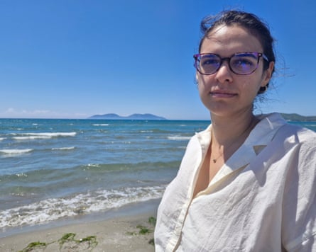 Ina Shkurti on a beach with a view of an island