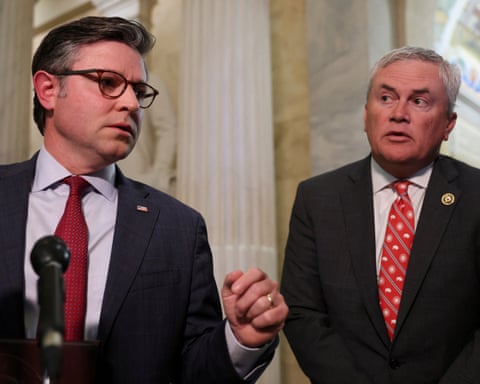 two men wearing suits and red ties