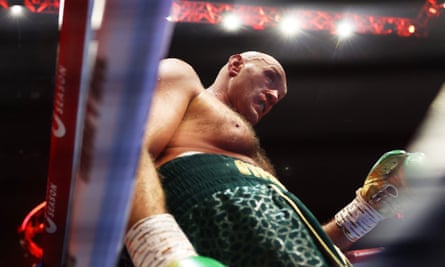 Tyson Fury looks tired as he leans against the ropes with a bloody nose