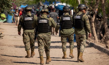 Members of the Mexican National Guard patrol in a refugee camp in Matamoros.