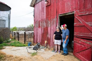 Joyce and John Blaske stand at the entrance to their barn at their farm in Onaga, Kansas.
