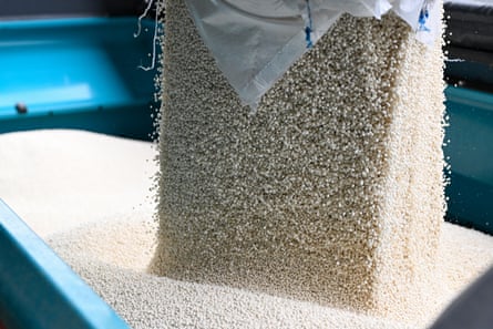 Ammonium nitrate fertiliser is poured into a spreader.