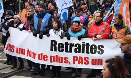 Protesters in Strasbourg, eastern France, hold a banner reading ‘Pensions: not one day more, not one euro less’ during a national strike on Tuesday.