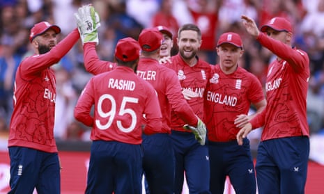England’s Chris Woakes (centre) is congratulated by team-mates after talking the wicket of India’s KL Rahul.