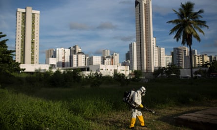 A municipal health worker sprays insecticide in an open area of a sports facility in Recife, Pernambuco state.