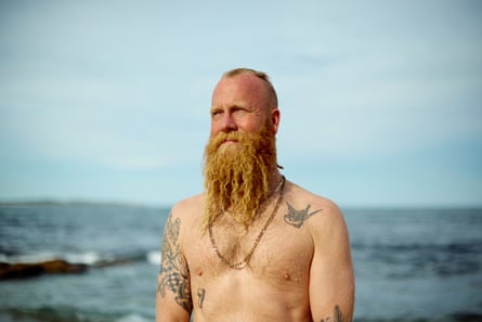 Blake Johnston, pictured shirtless against an water backdrop