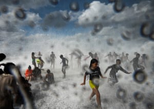 Children play in the waves at the Malecon in Havana, Cuba in the aftermath of Hurricane Ian