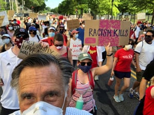 Mitt Romney marches during a protest against racial inequality in Washington on Sunday.