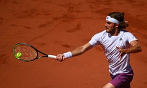 Stefanos Tsitsipas returns the ball to Novak Djokovic.