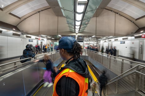 A Metropolitan Transportation Authority (MTA) worker sprays disinfectant and wipes an escalator handrail at the 86th St subway station in New York.