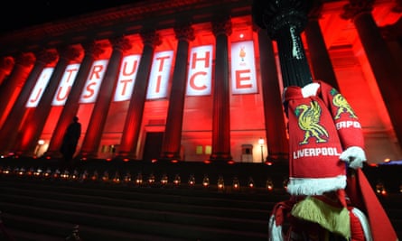 Liverpool scarves hang on a lamp-post as St George’s Hall is lit up in red in 2016.