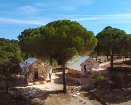 Exterior view of two larger tents at the Los Villares campsite in Cordoba, Spain. The campsite is amid pine-clad hills and surrounded by picnic spots and hiking trails.