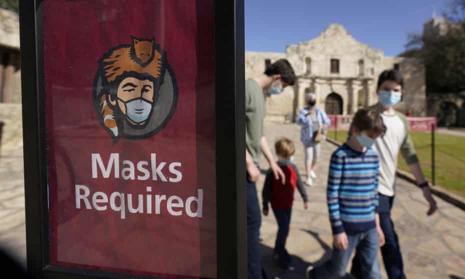 Visitors to the Alamo in San Antonio wear face masks on 3 March. 