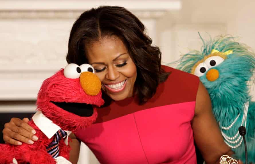 Michelle Obama with Sesame Street characters Elmo and Rosita after delivering remarks at the White House.