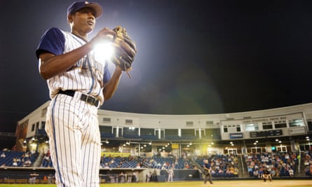 A man holding a baseball in Sugar
