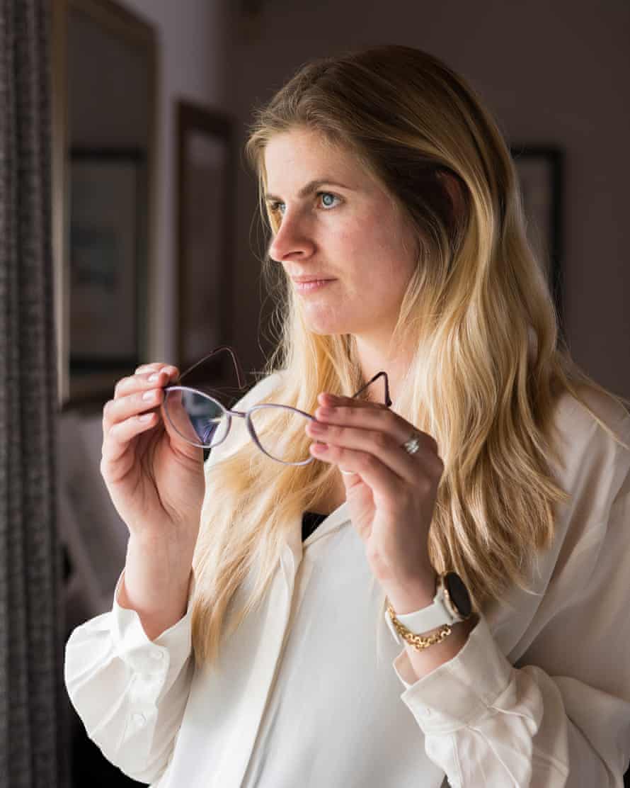 Lucy Crane holding a pair of glasses