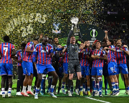 Crystal Palace’s Dean Henderson lifts the trophy as he celebrates with teammates after winning the UEFA Conference League