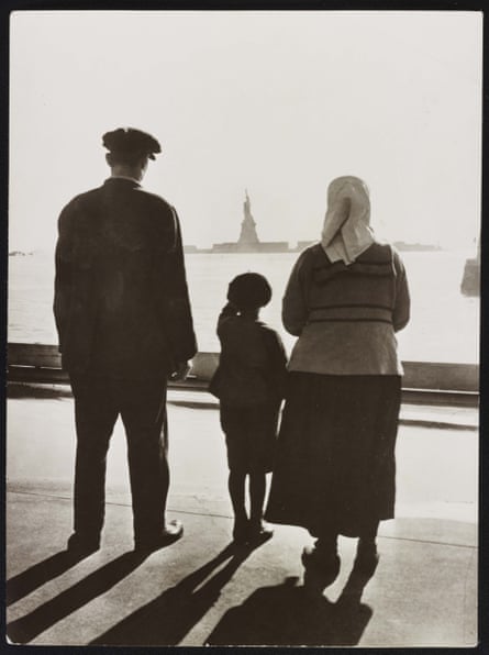 An immigrant family looking at Statue of Liberty from Ellis Island in 1930, used in The US and the Holocaust.