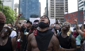 Christopher Bowman rallies demonstrators by City Hall in Philadelphia on Saturday.