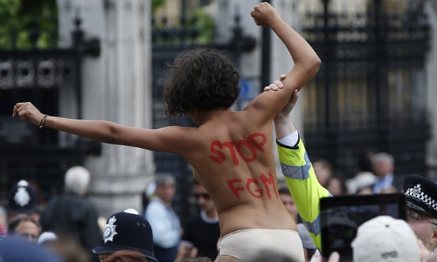 An activist protests against female genital mutilation opposite the Houses of Parliament in London.