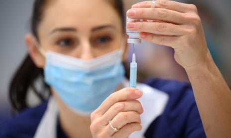 Medical staff prepare shots of the Moderna vaccine