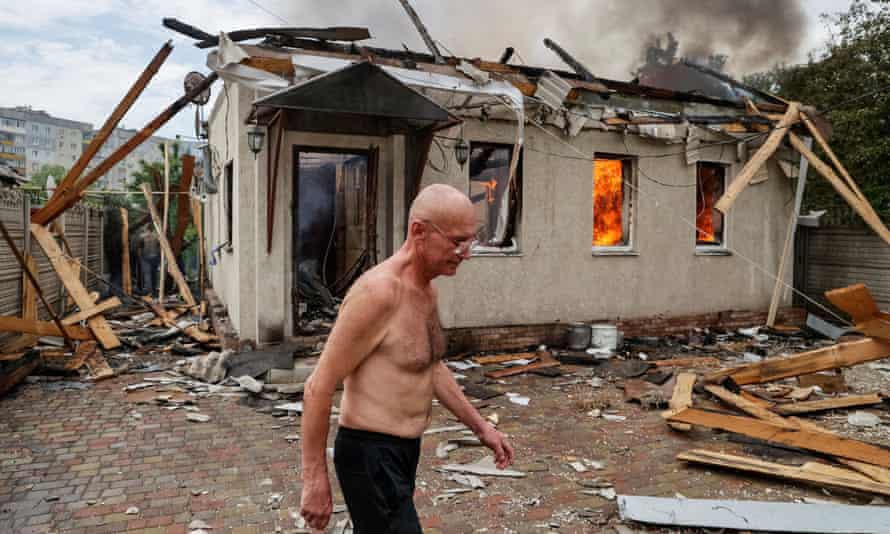 A local resident walks, as his neighbour’s house burns after shelling, as Russia’s attack on Ukraine continues, in Lysychansk, Luhansk region Ukraine June 2, 2022.