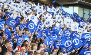Brighton fans wave flags.