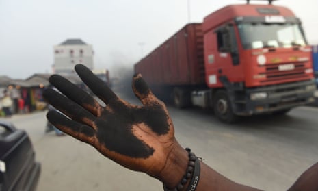 A resident’s soot covered hand from wiping the bonnet of his car in Port Harcourt.