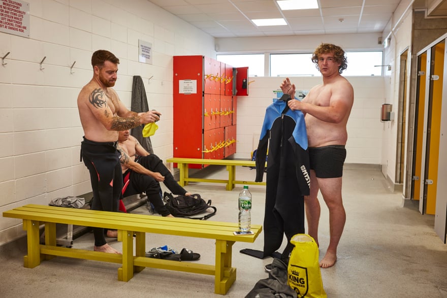 Steven Ferguson, 25 (right) gets into his wetsuit. ‘Ste’ as he his known to his friends, is a military veteran who served in the British armed forces for six years, enlisting as soon as he left school.